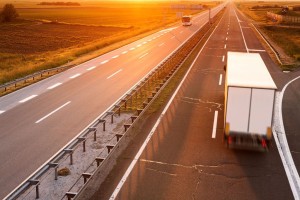 30573509 - truck and bus on highway in motion blur at sunset