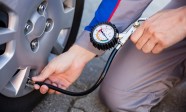 Person Measuring Car Tyre Pressure