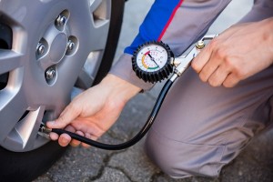 Person Measuring Car Tyre Pressure